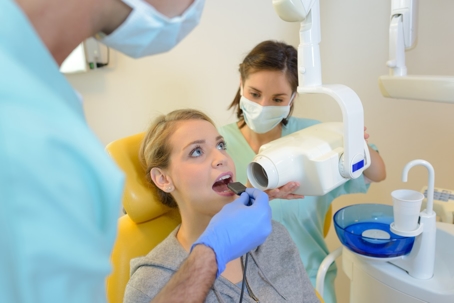 dentist conducting a dental x-ray on a woman