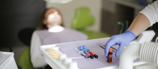 dental hygienist preparing to treat a patient