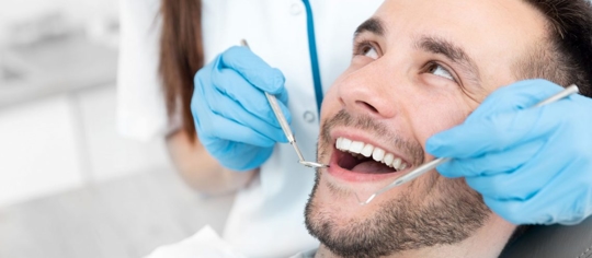 Man smiling while being treated on